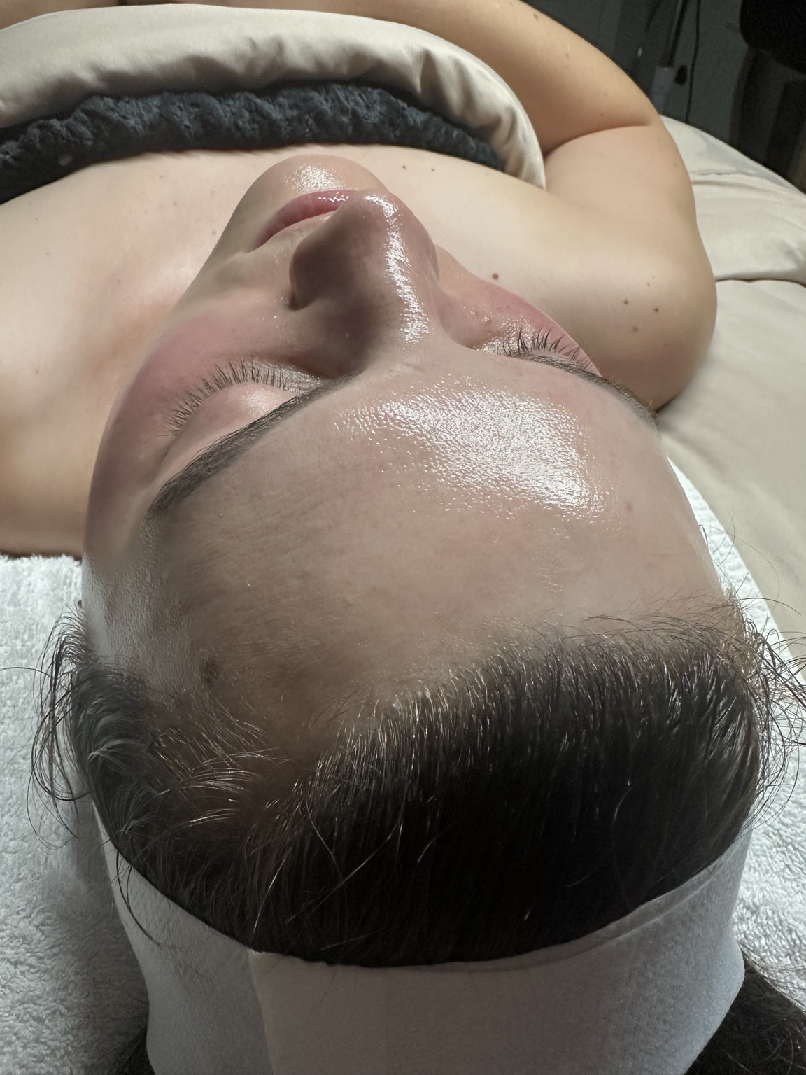 Client with glowing skin after a facial treatment